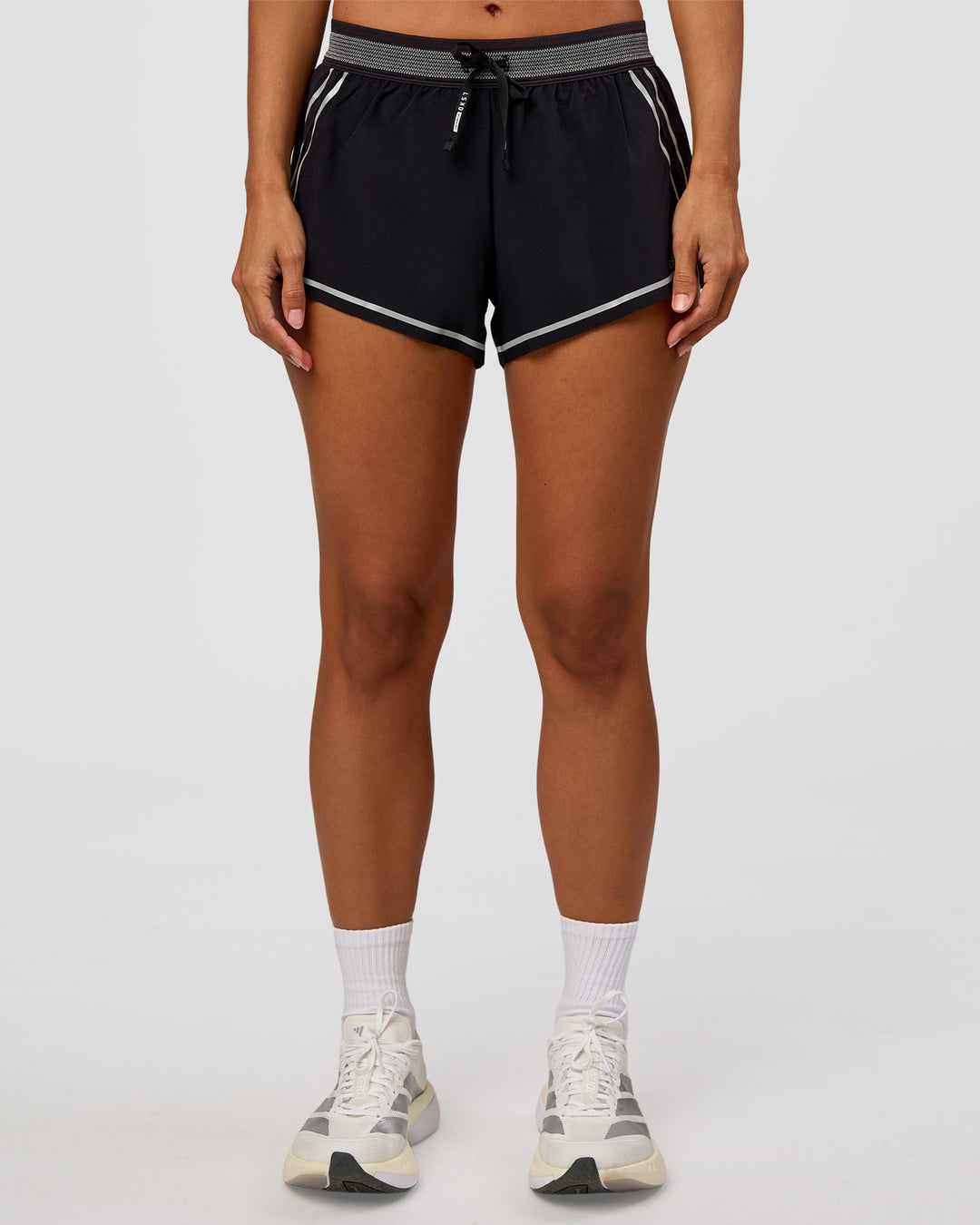 Woman wearing Accelerate 3" Reflective Mid-Rise Running Short - Black-Reflective | Set:true | Angle:front | Model:Brylee | Size:XS - view 9