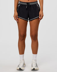 Woman wearing Accelerate 3" Reflective Mid-Rise Running Short - Black-Reflective | Set:true | Angle:front | Model:Brylee | Size:XS | Thumbnail Index: 8