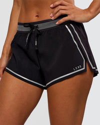 Woman wearing Accelerate 3" Reflective Mid-Rise Running Short - Black-Reflective | Set:true | Angle:closeup | Model:Brylee | Size:XS | Thumbnail Index: 0