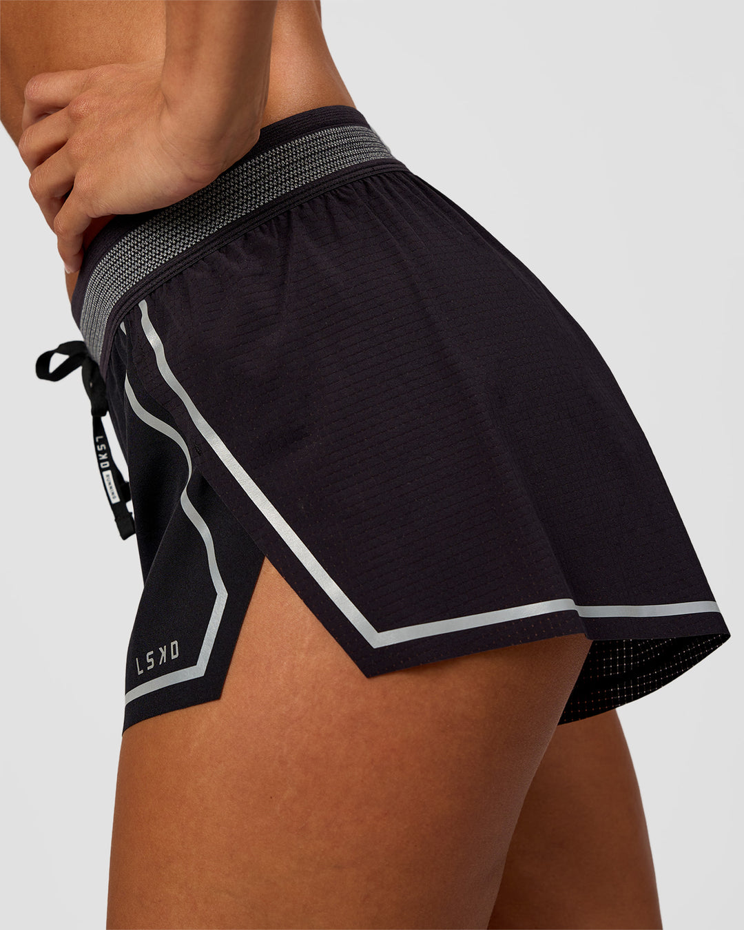 Woman wearing Accelerate 3" Reflective Mid-Rise Running Short - Black-Reflective | Model:Brylee | Size:XS - view 8