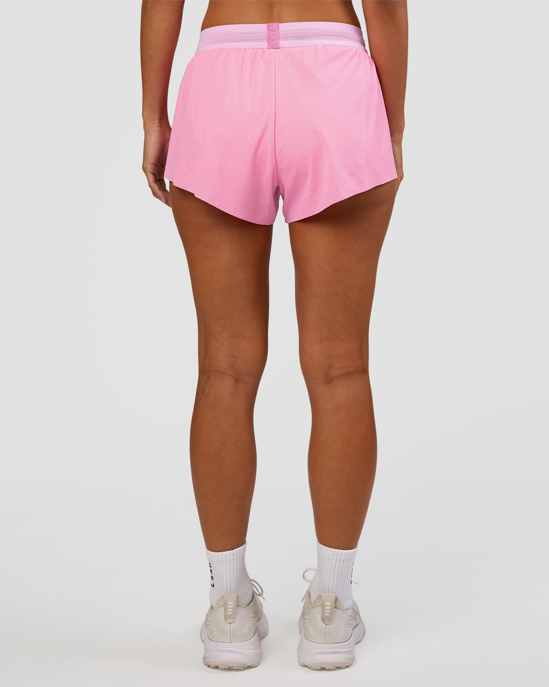 Woman wearing Accelerate 3" Mid-Rise Running Short - Candy Pink-Marshmallow | Set:true | Angle:back | Model:Brylee | Size:XS - view 4