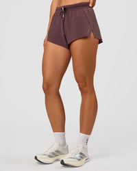Woman wearing Accelerate 3" Mid-Rise Running Short - Cocoa Powder | Set:true | Angle:side | Model:Maja | Size:XS | Thumbnail Index: 0
