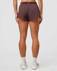 Woman wearing Accelerate 3" Mid-Rise Running Short - Cocoa Powder | Set:true | Angle:back | Model:Maja | Size:XS | Thumbnail Index: 3