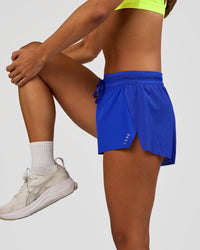 Woman wearing Accelerate 3" Mid-Rise Running Short - Electric Indigo | Model:Brylee | Size:XS | Thumbnail Index: 7