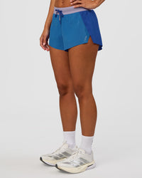 Woman wearing Accelerate 3" Mid-Rise Running Short - Electric Indigo-Multi | Set:true | Angle:side | Model:Brylee | Size:XS | Thumbnail Index: 5