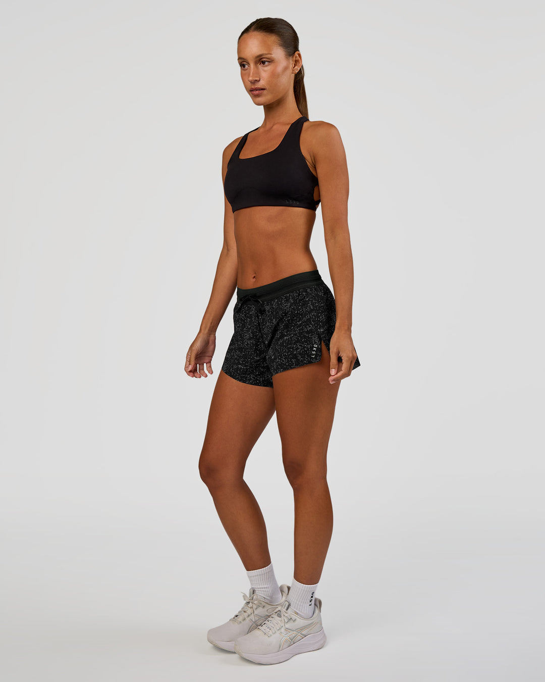 Woman wearing Accelerate 3" Mid-Rise Running Short - Energy Print Black | Model:Brylee | Size:XS - view 6