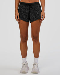 Woman wearing Accelerate 3" Mid-Rise Running Short - Energy Print Black | Set:true | Angle:front | Model:Brylee | Size:XS | Thumbnail Index: 6
