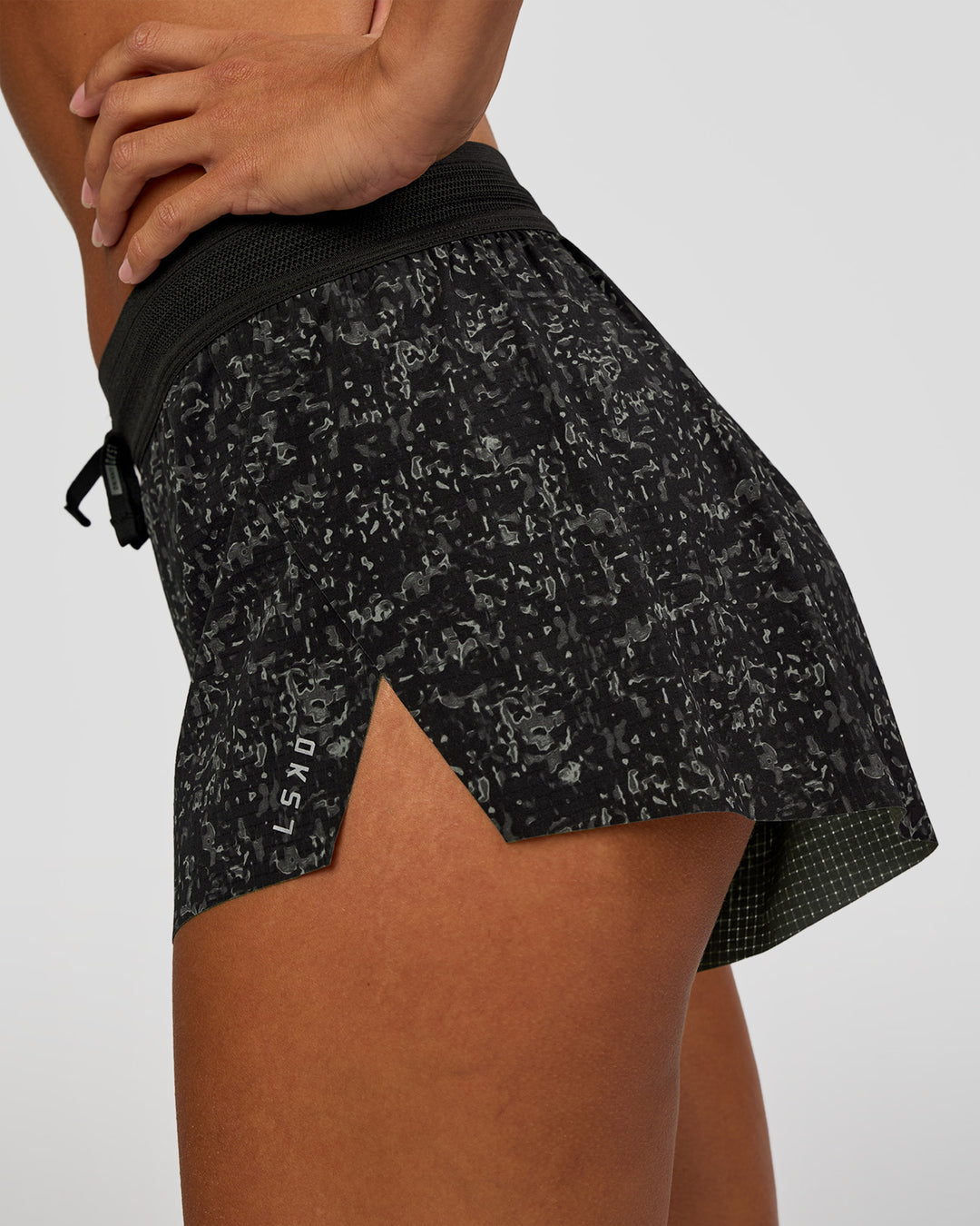 Woman wearing Accelerate 3" Mid-Rise Running Short - Energy Print Black | Model:Brylee | Size:XS - view 4