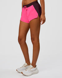 Woman wearing Accelerate 3" Mid-Rise Running Short - Midnight Plum-Sugar Plum | Set:True | Angle:side | Model:Charli | Size:XS | Thumbnail Index: 0
