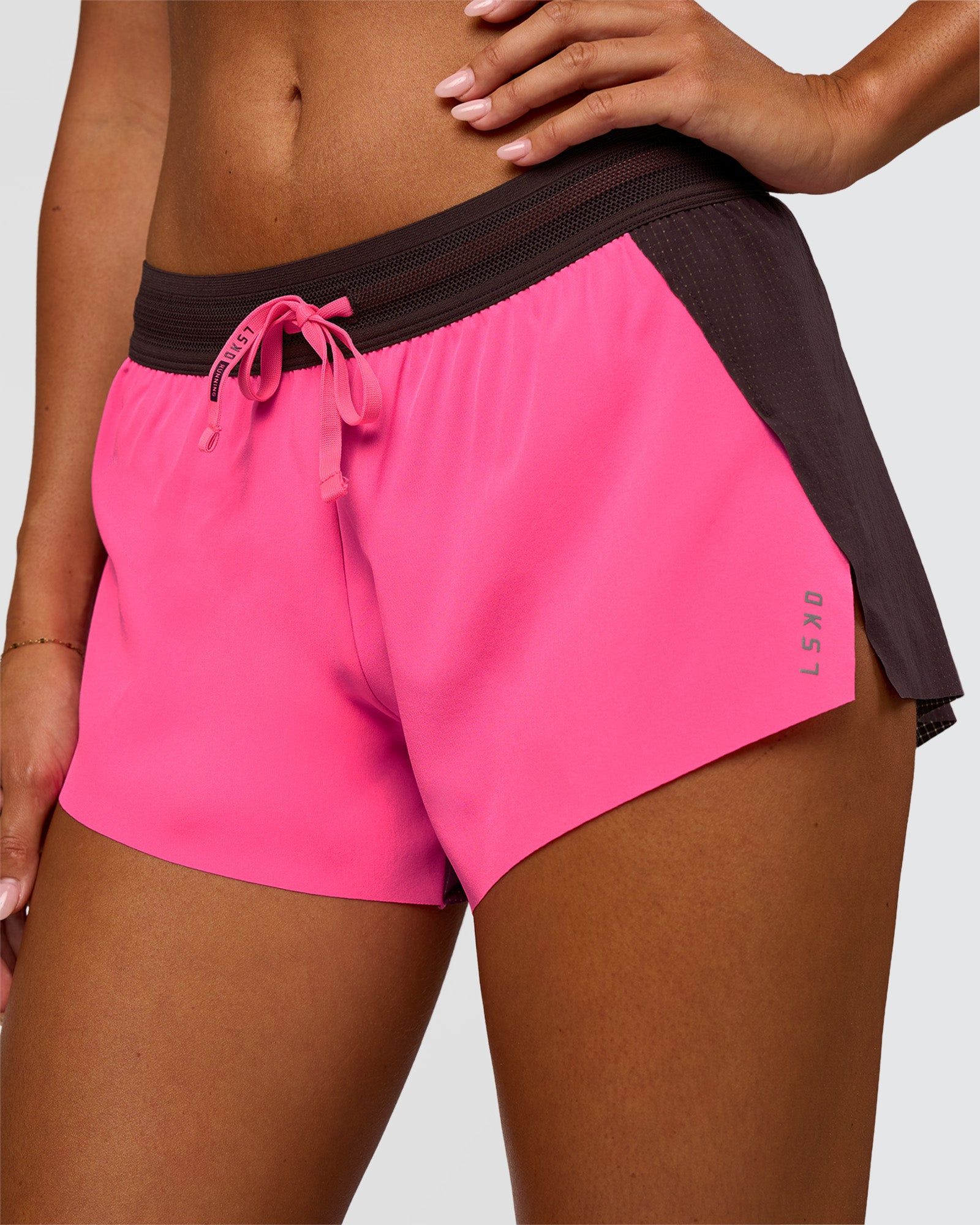 Woman wearing Accelerate 3" Mid-Rise Running Short - Midnight Plum-Sugar Plum | Set:True | Angle:closeup | Model:Charli | Size:XS