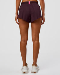 Woman wearing Accelerate 3" Mid-Rise Running Short - Midnight Plum-Sugar Plum | Set:True | Angle:back | Model:Charli | Size:XS | Thumbnail Index: 3
