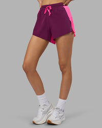Woman wearing Accelerate 3" High-Rise Running Short - Ultra Pink-Plum Caspia | Set:true | Angle:side | Model:Leilani | Size:XS | Thumbnail Index: 0