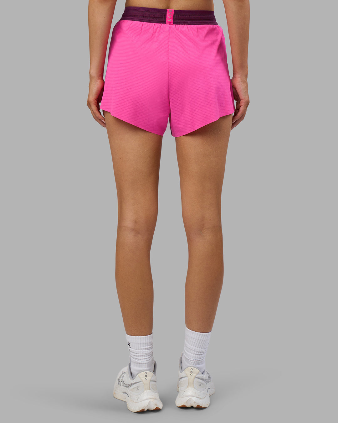 Woman wearing Accelerate 3" High-Rise Running Short - Ultra Pink-Plum Caspia | Set:true | Angle:back | Model:Leilani | Size:XS - view 4