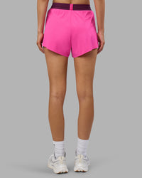 Woman wearing Accelerate 3" High-Rise Running Short - Ultra Pink-Plum Caspia | Set:true | Angle:back | Model:Leilani | Size:XS | Thumbnail Index: 3