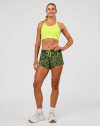 Woman wearing Accelerate Split Strap Sports Bra - Hyper Green | Model:Emelia | Size:XS | Thumbnail Index: 4