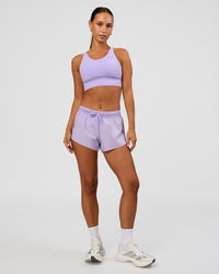 Woman wearing Accelerate Split Strap Sports Bra - Pale Lilac | Model:Brylee | Size:XS | Thumbnail Index: 2