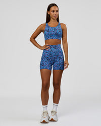 Woman wearing Accelerate Sports Bra in Energy Print Blue Multi | Model:Brylee | Size:XS | Thumbnail Index: 2
