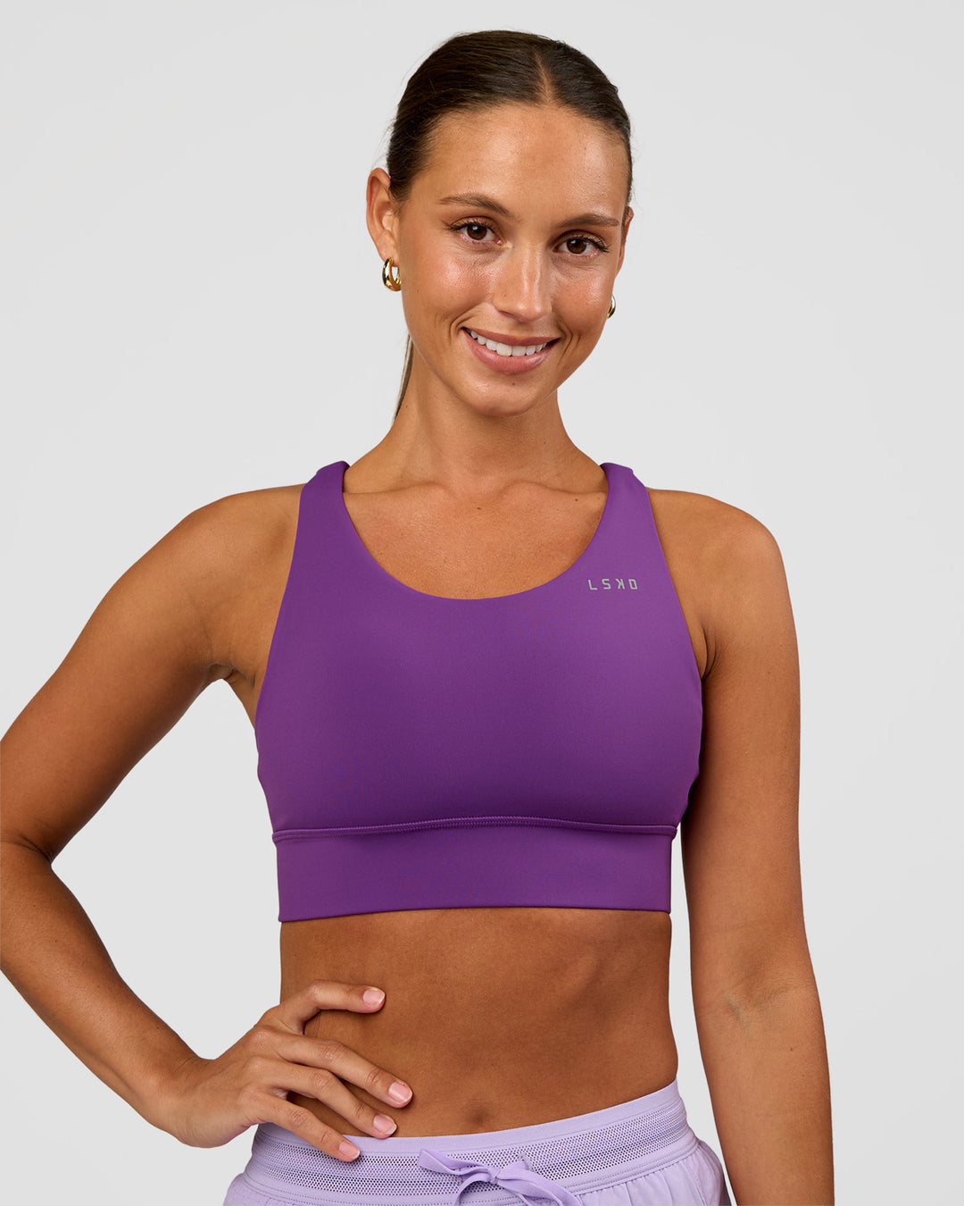 Woman wearing Accelerate Sports Bra - Fresh Purple | Set:true | Angle:front | Model:Brylee | Size:XS - view 1