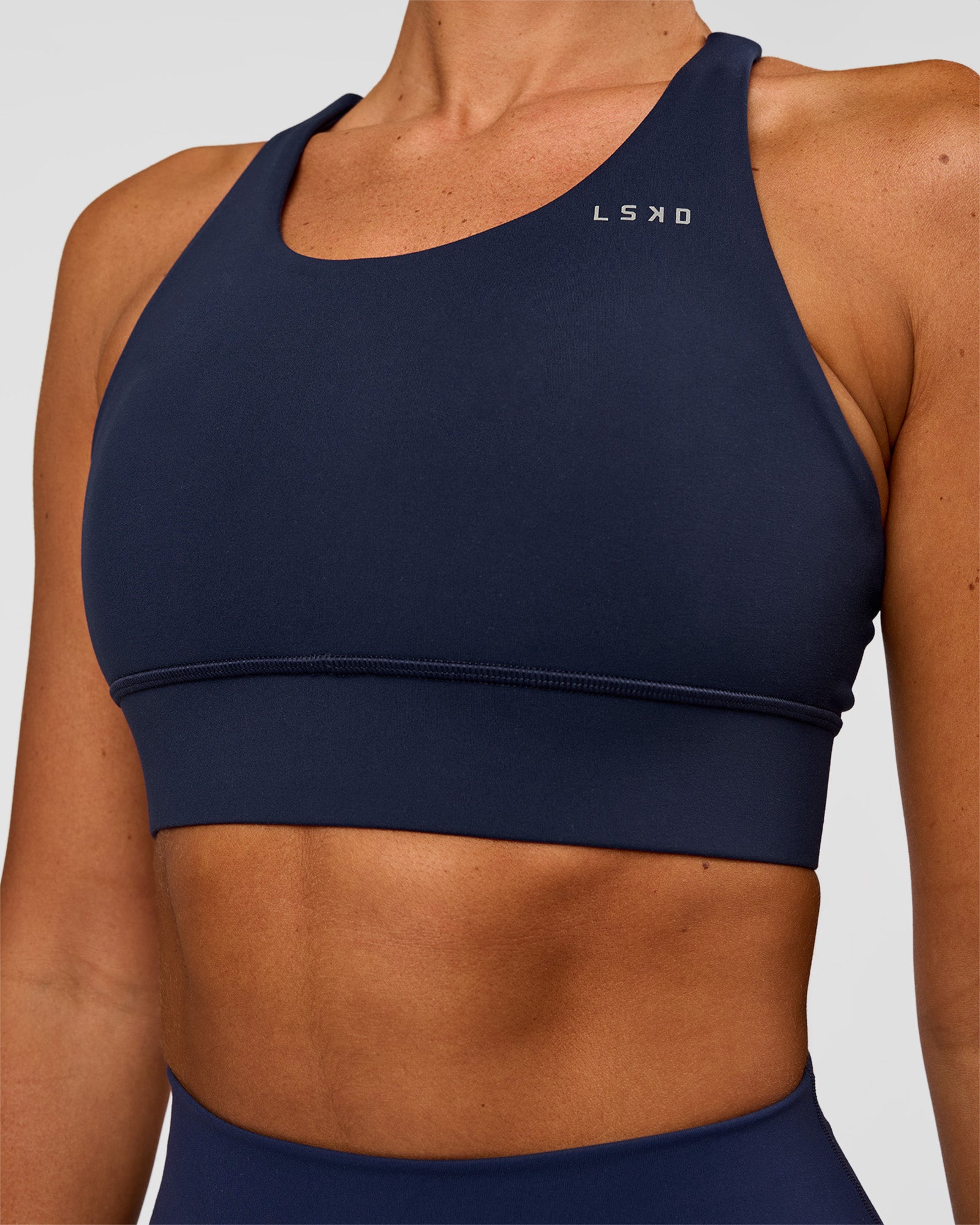 Woman wearing Accelerate Sports Bra - Future Navy | Model:Charlie | Size:XS