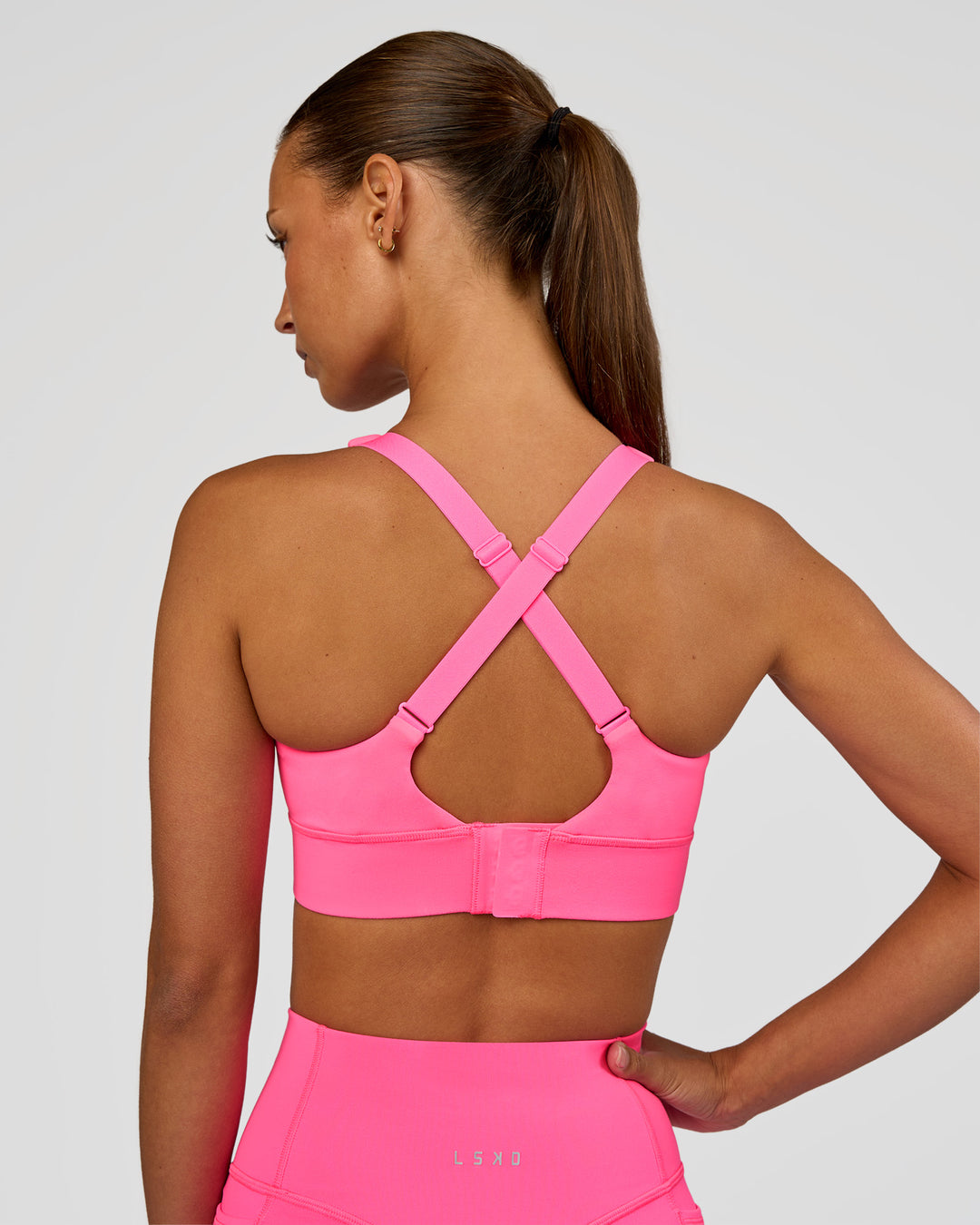 Woman wearing Accelerate Sports Bra - Sugar Plum | Set:true | Angle:back | Model:Brylee | Size:XS - view 6