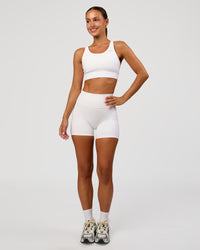 Woman wearing Accelerate Sports Bra - White | Model:Brylee | Size:XS | Thumbnail Index: 2