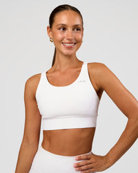 Woman wearing Accelerate Sports Bra - White | Set:true | Angle:front | Model:Brylee | Size:XS | Thumbnail Index: 0