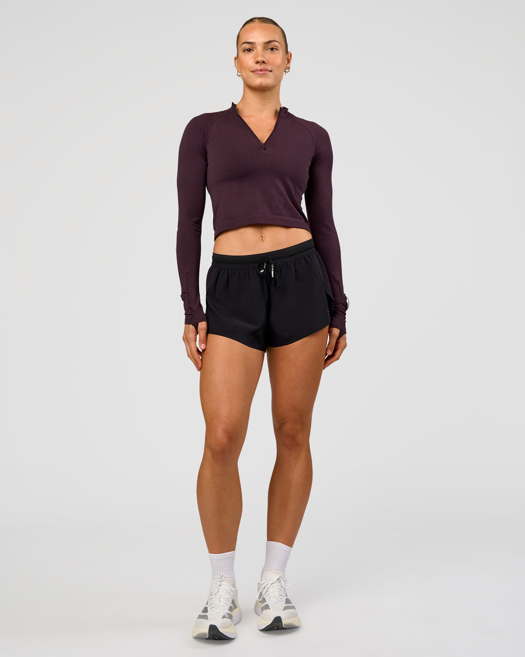 Woman wearing AeroFLX+ Long Sleeve Skimmer Half Zip - Midnight Plum/Midnight Plum | Model:Maja | Size:XS - view 6