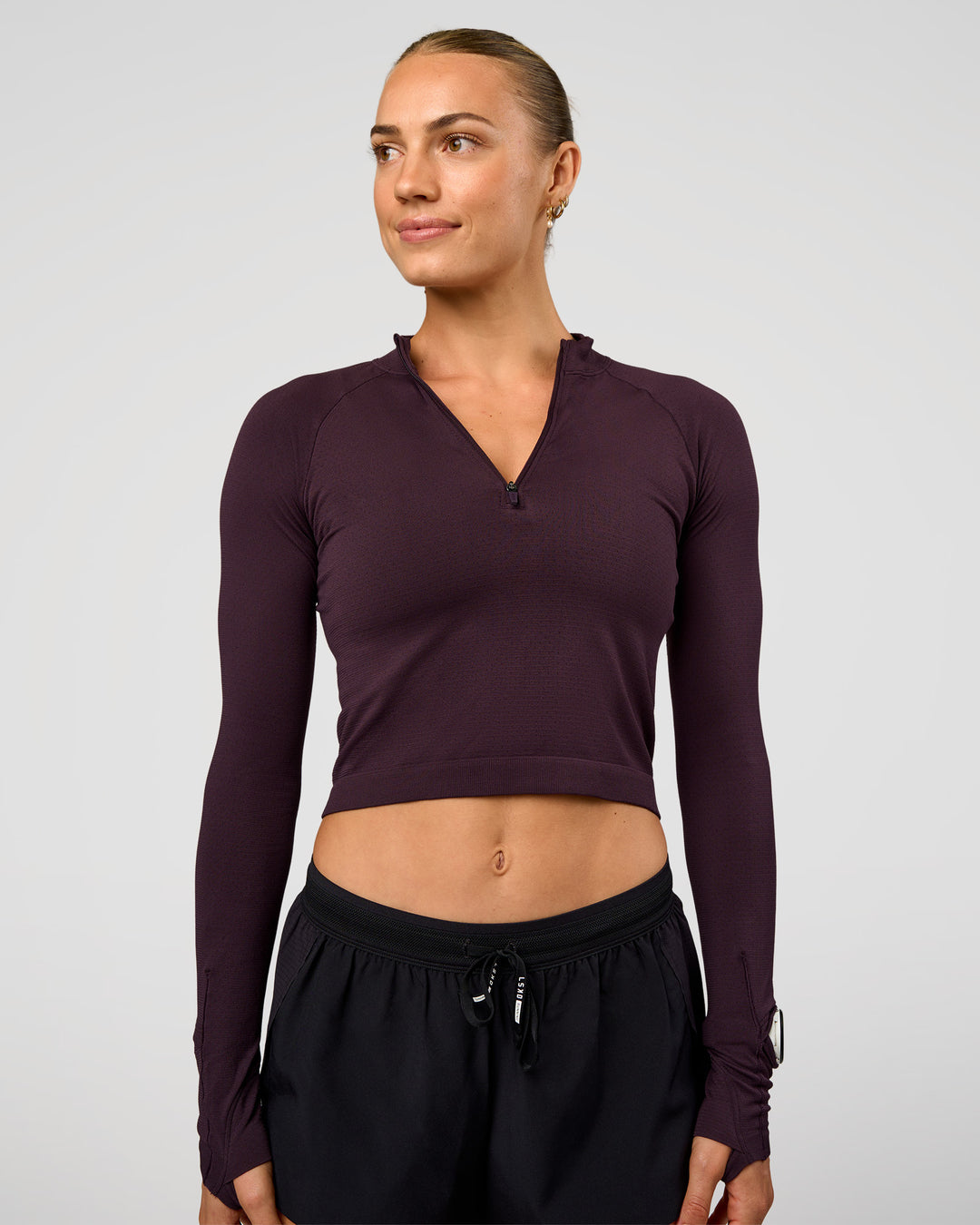 Woman wearing AeroFLX+ Long Sleeve Skimmer Half Zip - Midnight Plum/Midnight Plum | Model:Maja | Size:XS - view 1