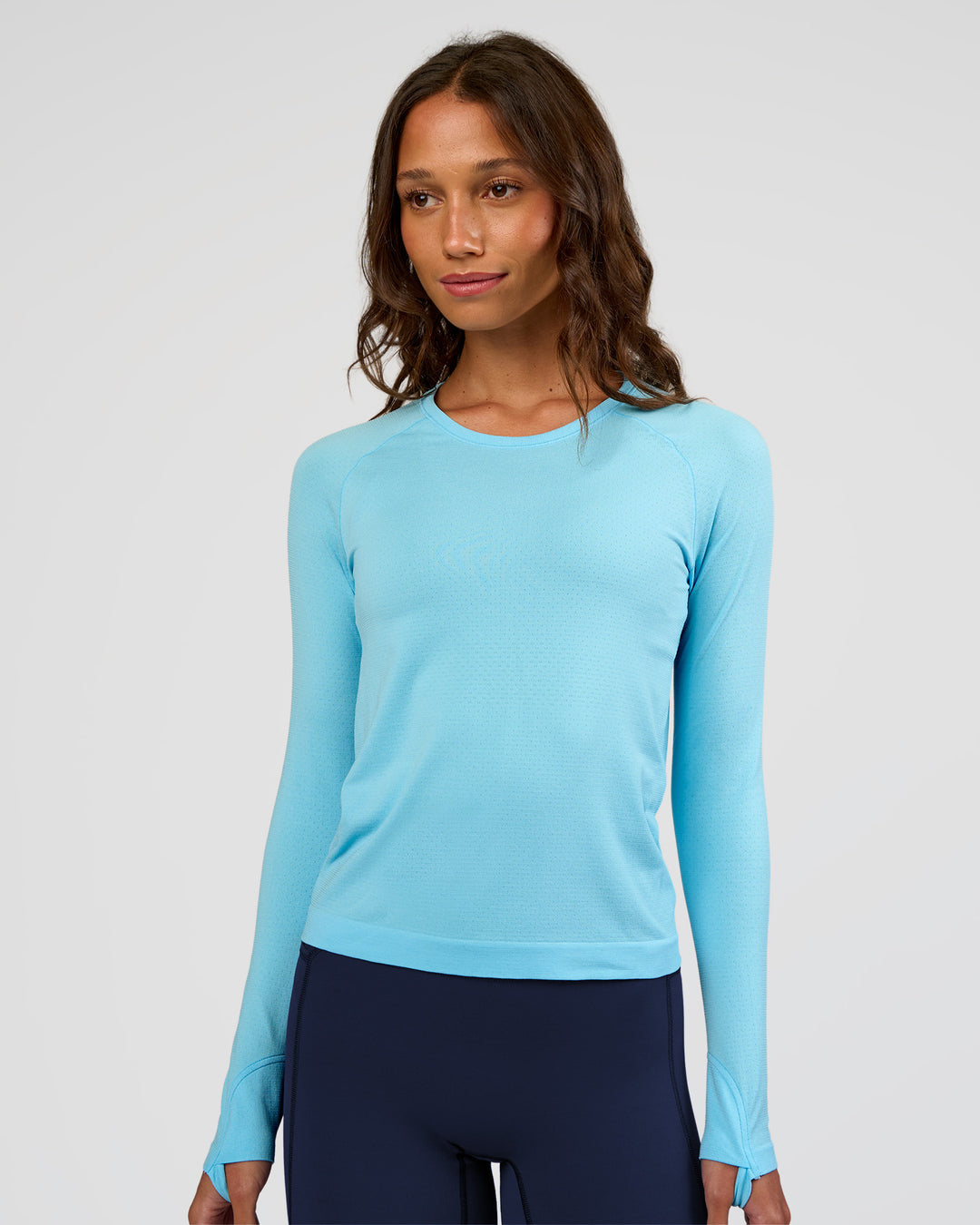 Woman wearing AeroFLX+ Seamless Long Sleeve Tee - Baltic Sea/Baltic Sea | Model:Dakota | Size:XS - view 1