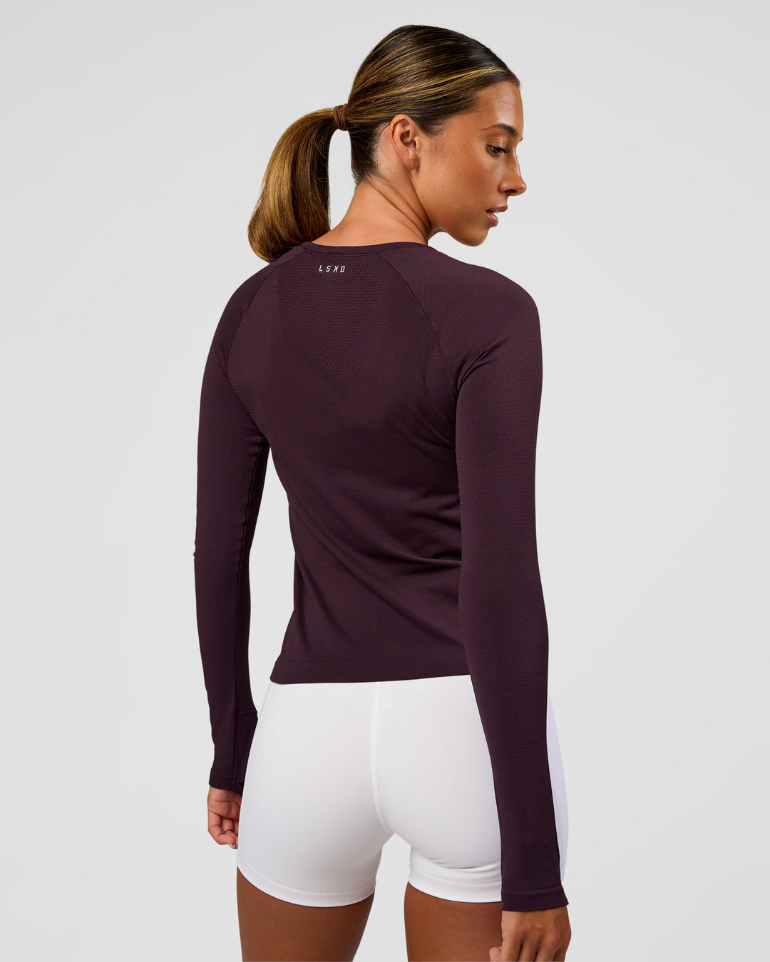 Woman wearing AeroFLX+ Seamless Long Sleeve Tee - Midnight Plum/Midnight Plum | Model:Charli | Size:XS - view 8