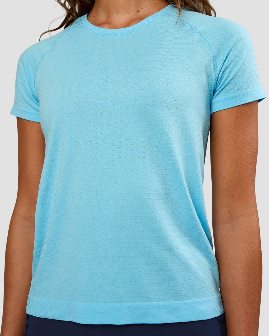 Woman wearing AeroFLX+ Seamless Tee - Baltic Sea/Baltic Sea | Model:Dakota | Size:XS - view 3