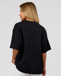 Woman wearing AfterDark ZeroCrease Boxy Tee in Black | Model:Issy | Size:XS | Thumbnail Index: 16