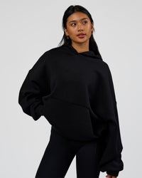 Woman wearing AfterDark ZeroCrease Oversized Hoodie - Black | Model:Loren | Size:XS | Thumbnail Index: 11
