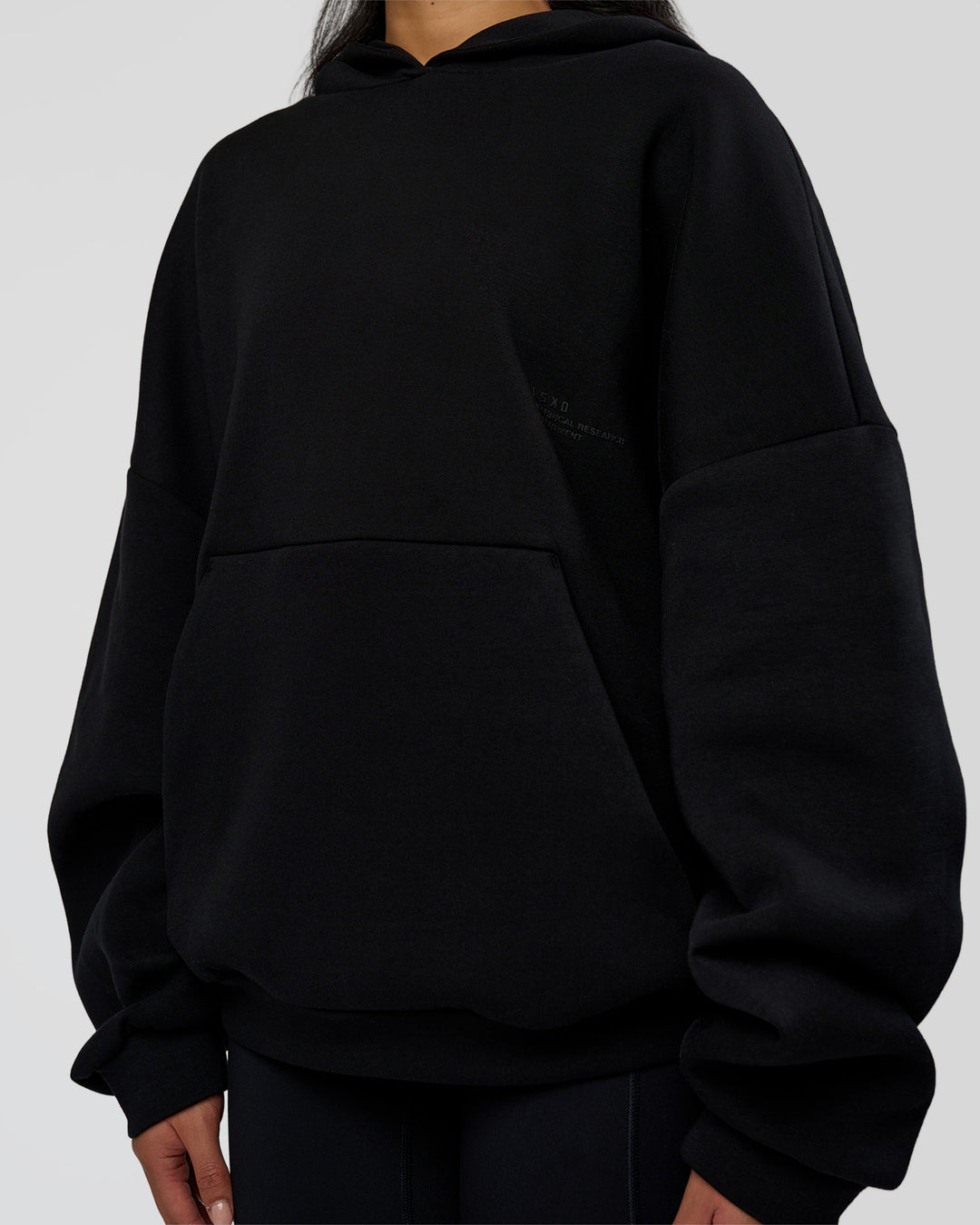 Woman wearing AfterDark ZeroCrease Oversized Hoodie - Black | Model:Loren | Size:XS - view 13
