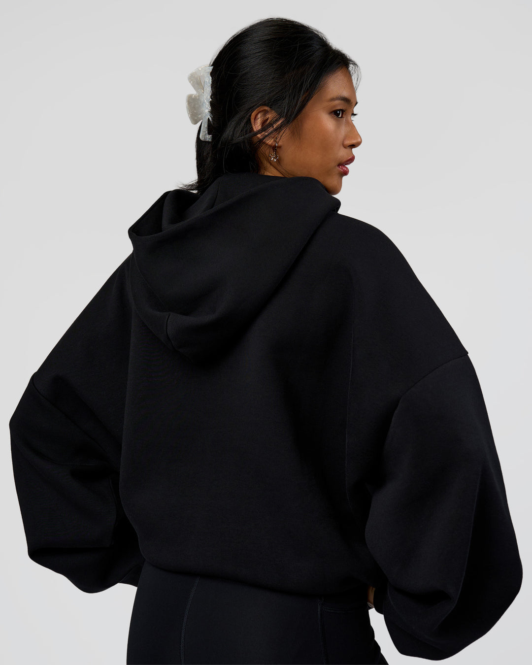 Woman wearing AfterDark ZeroCrease Oversized Hoodie - Black | Model:Loren | Size:XS - view 8