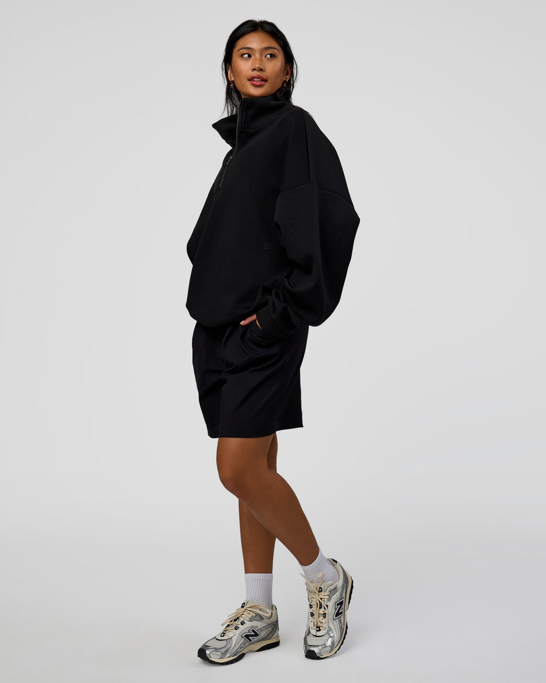 Woman wearing AfterDark ZeroCrease Quarter Zip - Black | Model:Loren | Size:XS - view 5