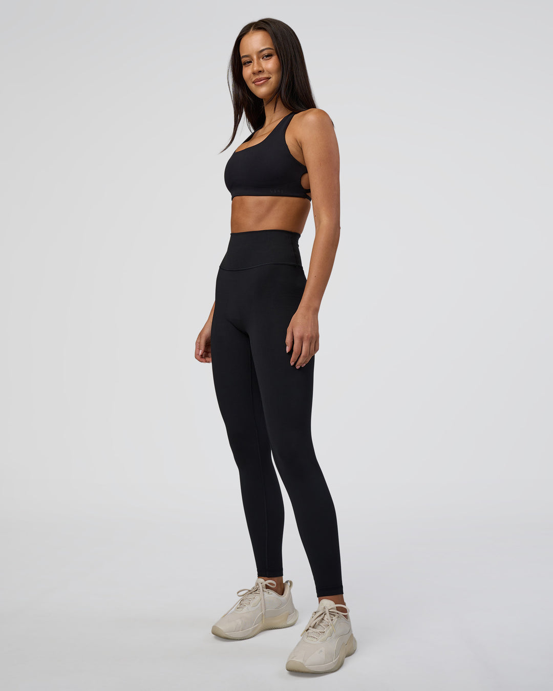 Woman wearing Aspire Sports Bra - Black | Model:Eliza | Size:XS - view 6
