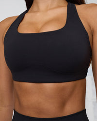 Woman wearing Aspire Sports Bra - Black | Model:Eliza | Size:XS | Thumbnail Index: 4