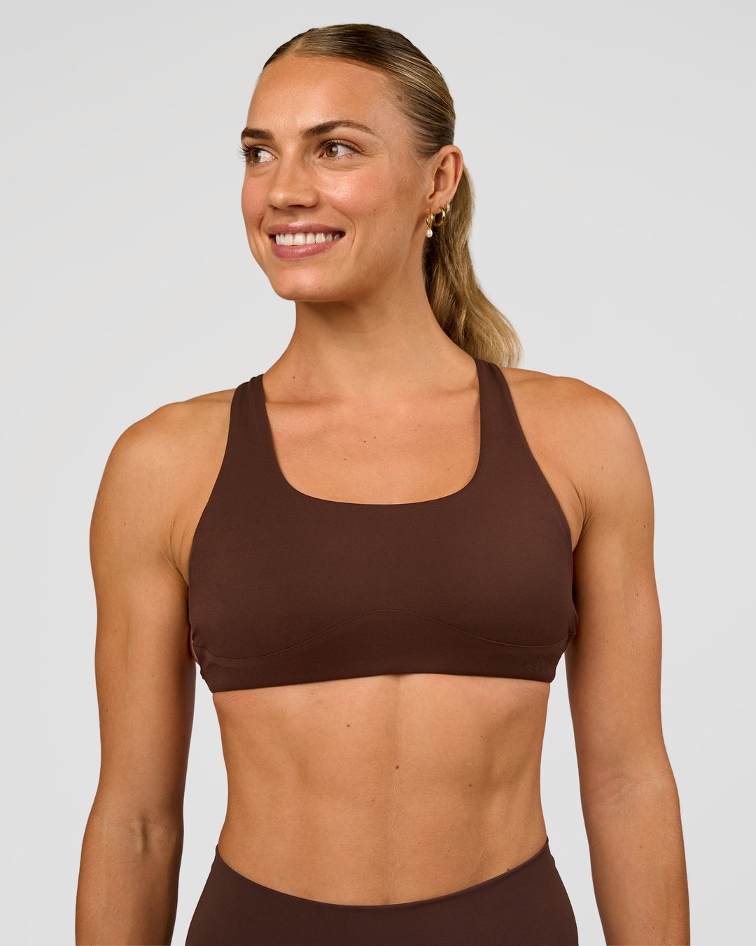Woman wearing Aspire Sports Bra - Hot Chocolate | Model:Maja | Size:XS - view 2