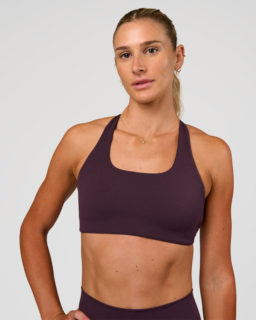 Woman wearing Aspire Sports Bra - Midnight Plum | Model:Emelia | Size:XS - view 6