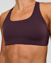 Woman wearing Aspire Sports Bra - Midnight Plum | Model:Emelia | Size:XS | Thumbnail Index: 2