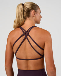 Woman wearing Aspire Sports Bra - Midnight Plum | Model:Emelia | Size:XS | Thumbnail Index: 1
