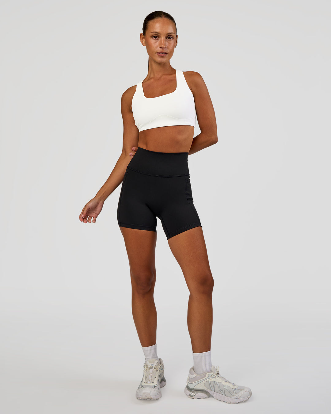 Woman wearing Aspire Sports Bra - White | Model:Brylee | Size:XS - view 3