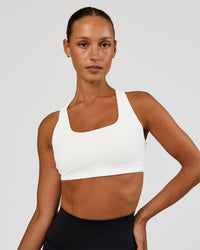 Woman wearing Aspire Sports Bra - White | Model:Brylee | Size:XS | Thumbnail Index: 0