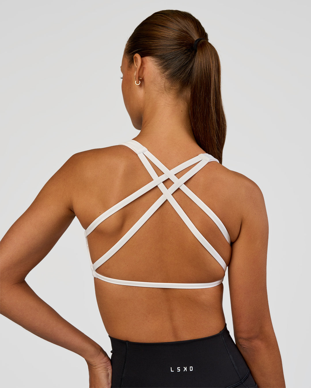 Woman wearing Aspire Sports Bra - White | Model:Brylee | Size:XS - view 5