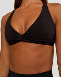 Woman wearing Aspire Twist Sports Bra - Black | Model:Brylee | Size:XS | Thumbnail Index: 3