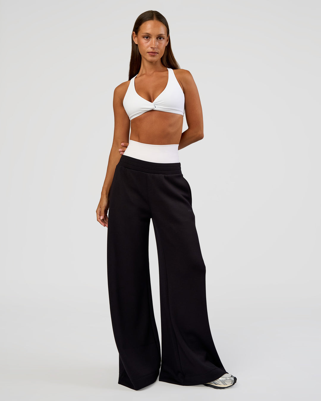 Woman wearing Aspire Twist Sports Bra - White | Model:Brylee | Size:XS - view 6