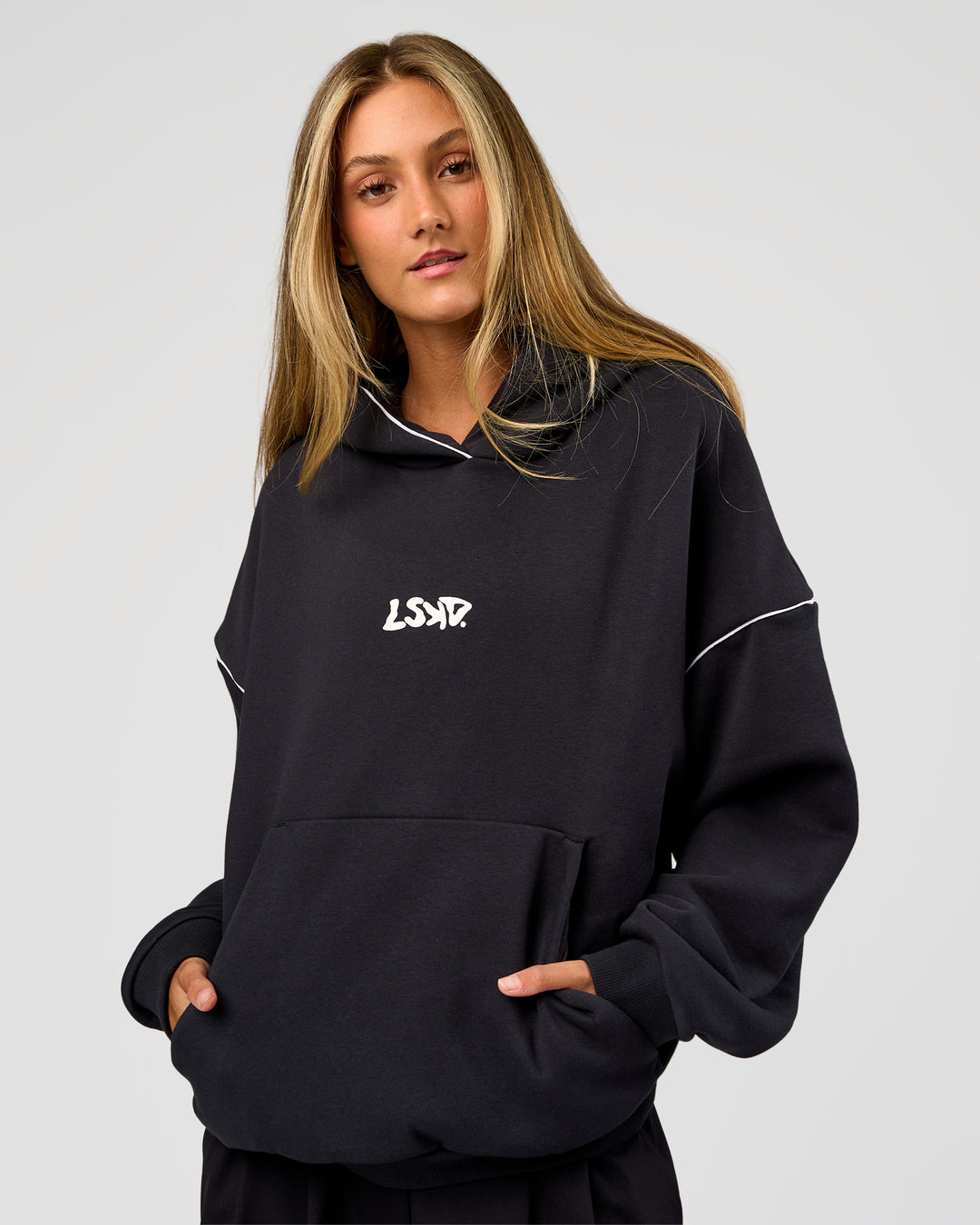 Woman wearing Axis Oversized Hoodie - Caviar-White | Model:Georgia | Size:XS - view 4