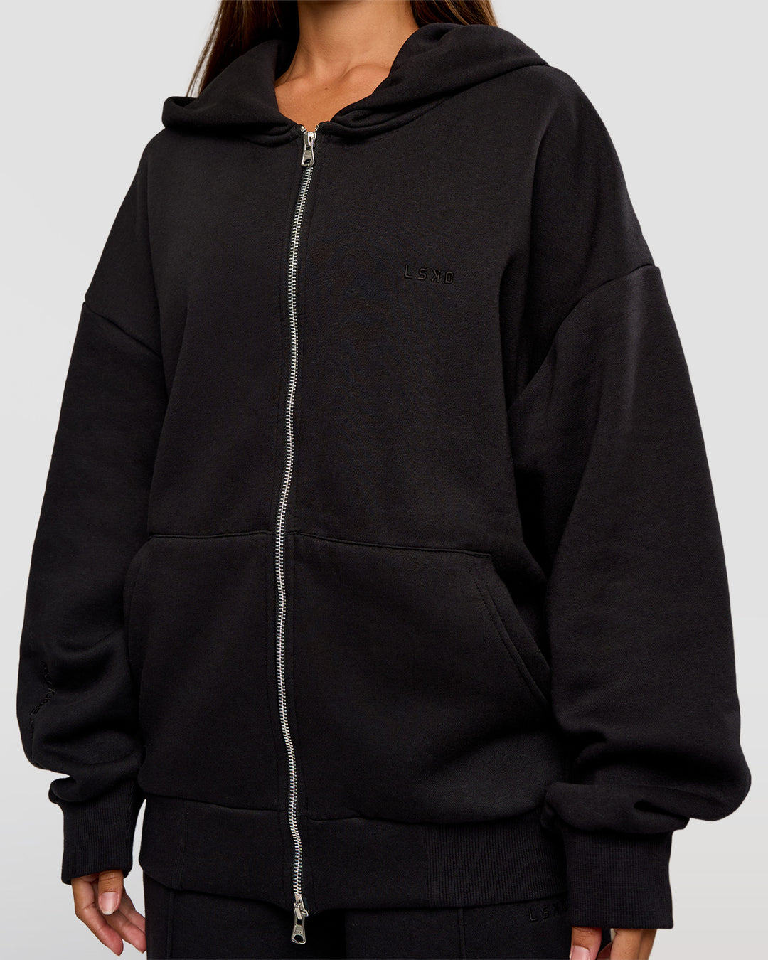 Woman wearing Base Zip Through Oversized Hoodie - Black | Model:Brylee | Size:XS - view 9