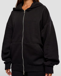 Woman wearing Base Zip Through Oversized Hoodie - Black | Model:Brylee | Size:XS | Thumbnail Index: 8